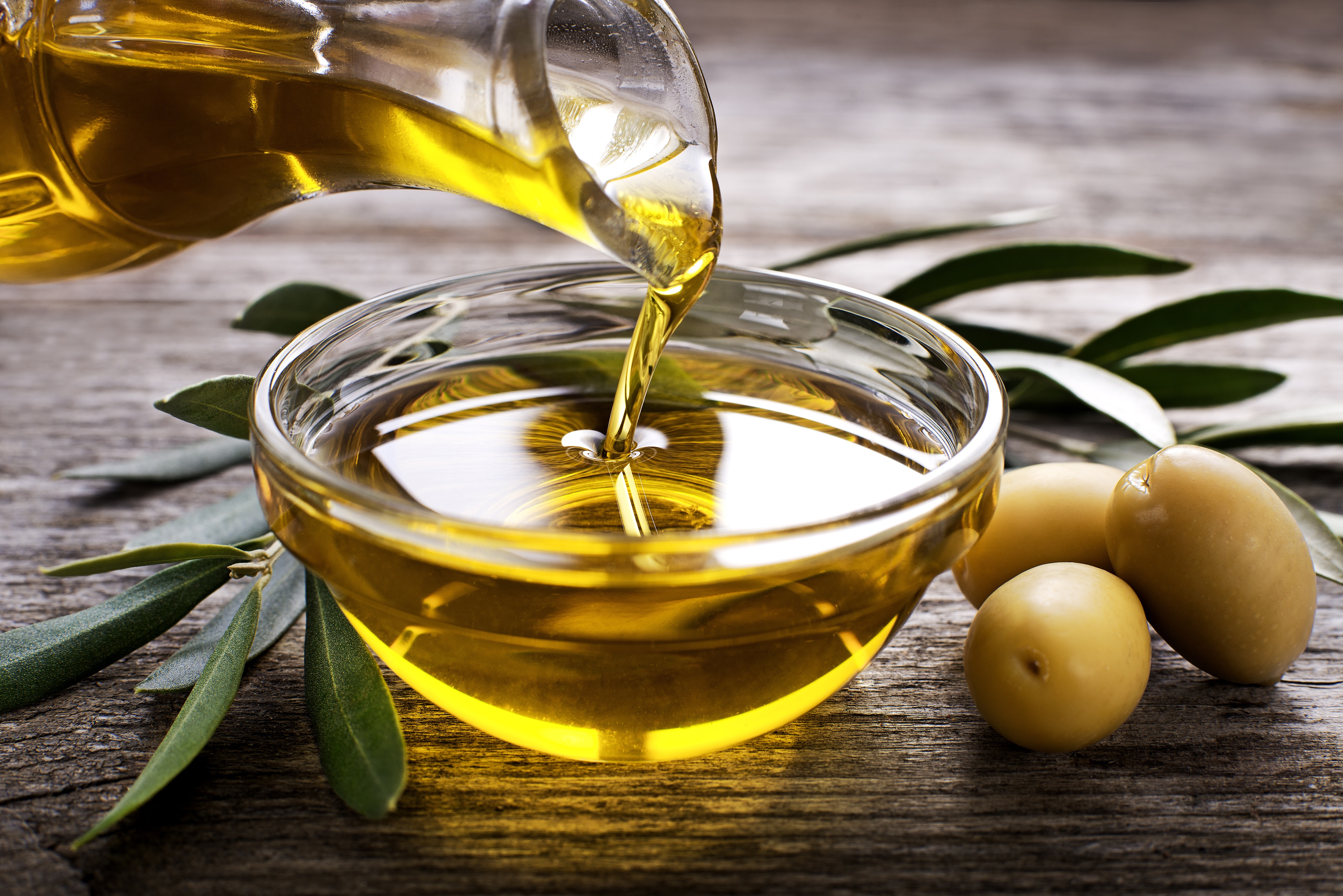 Olive Oil Being Poured Into Bowl